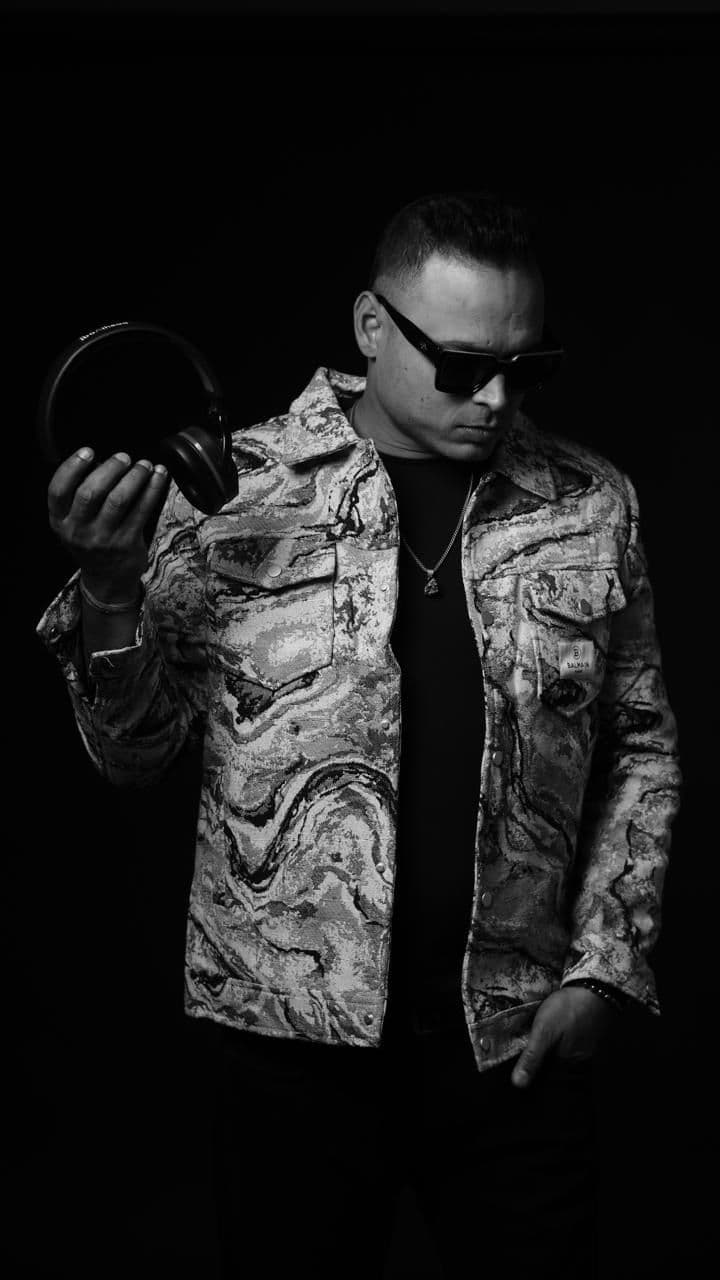 DJ Ashnotic holding headphones